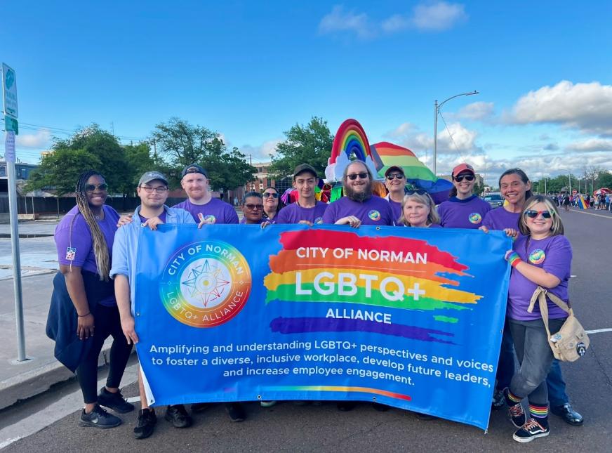 Members of the LGBTQ+ Alliance holding the Alliance Banner